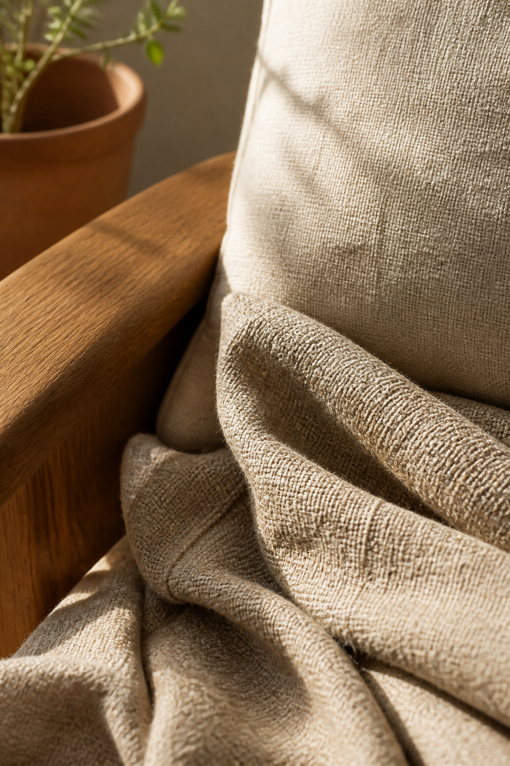 Slub linen's irregular weave caught in raking window light — a fabric that earns its place by improving with each wash and year of honest use.