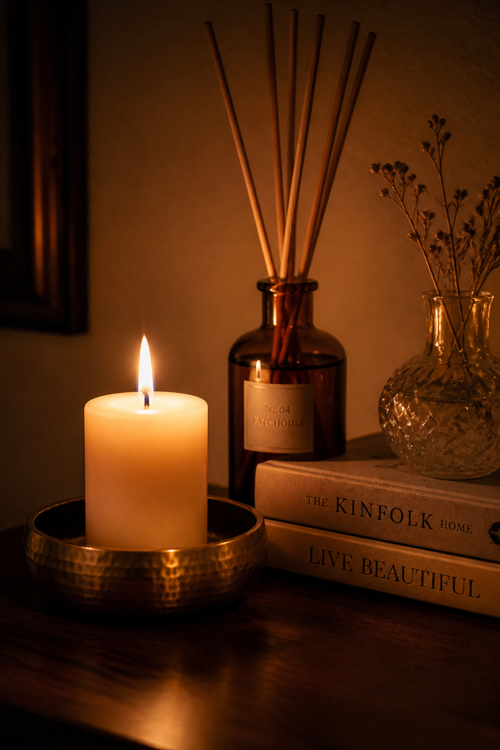 A single pillar candle and a reed diffuser in the same scent family create layered fragrance that sets a mood before you've changed a single piece of furniture.