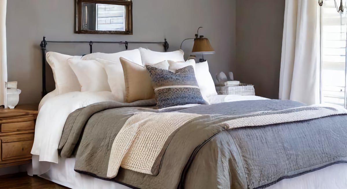 Cozy bed with neutral colored bedding