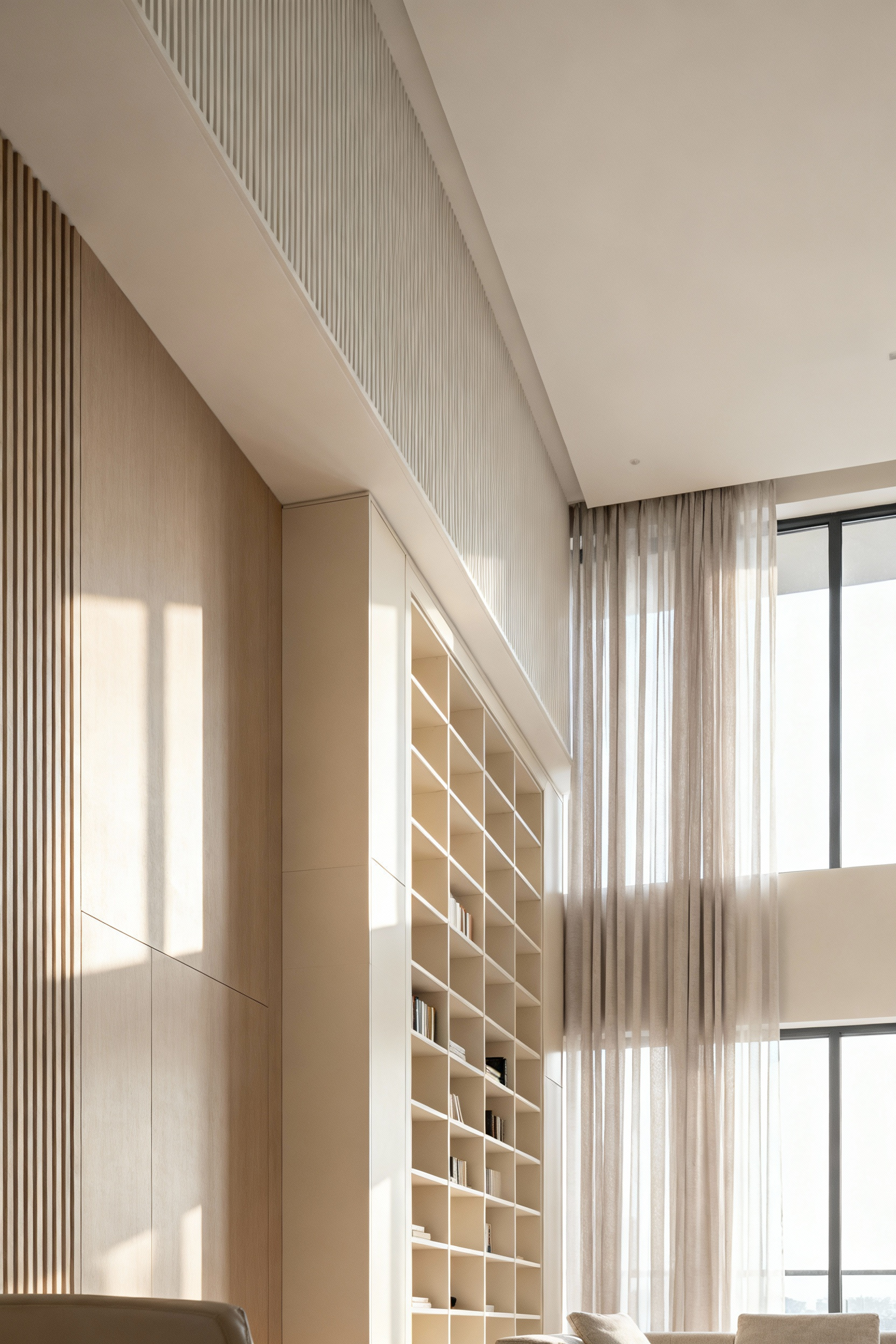 Modern living room with high ceilings, featuring floor-to-ceiling custom built-in shelving, tall sheer window drapery, and vertical wood paneling to emphasize verticality and create a spacious feel. Elegant, minimalist, no people.