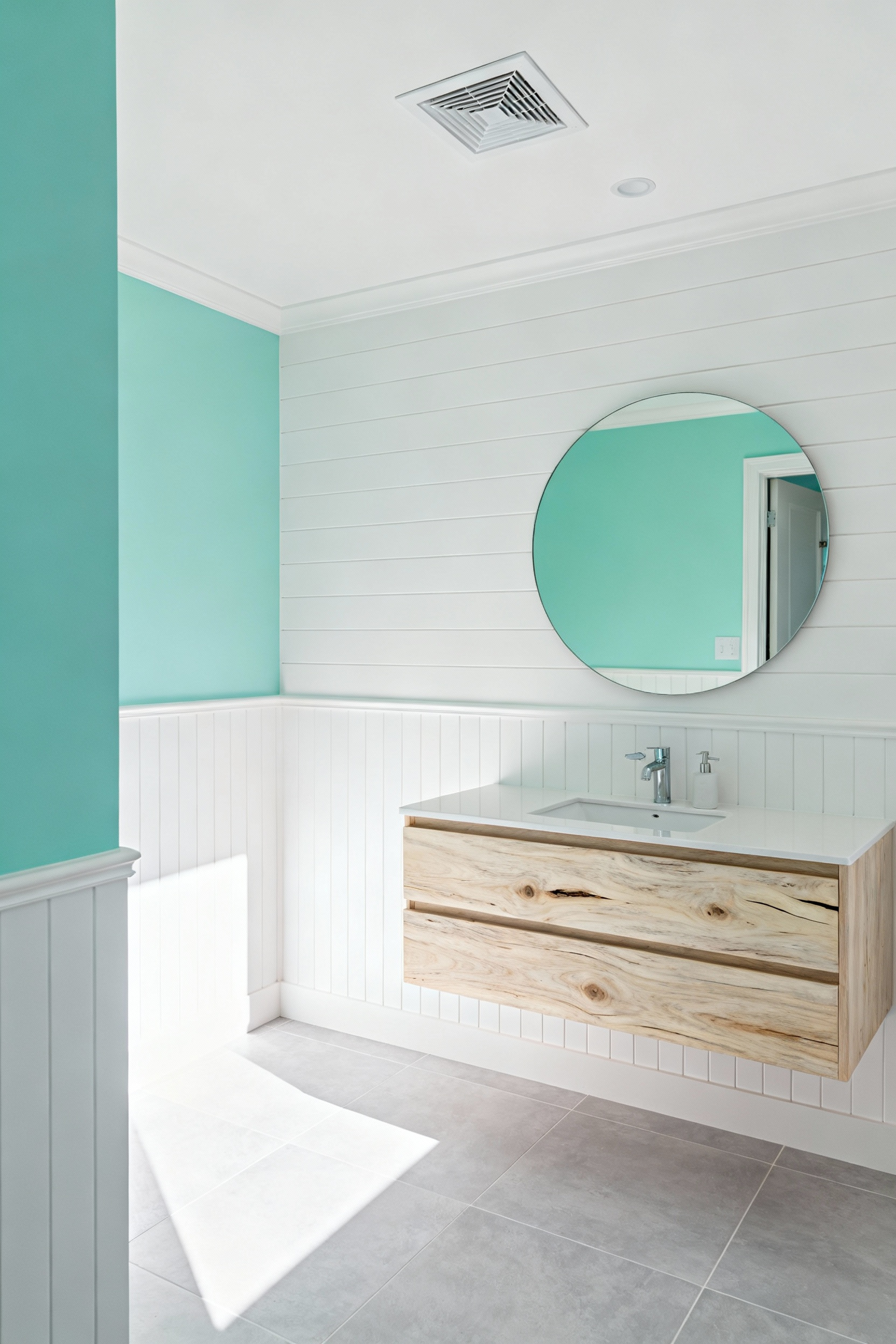 A pristine, newly renovated coastal bathroom featuring shiplap walls, a pale oak vanity, and a discreet, modern humidity-sensing exhaust fan visible in the white ceiling.