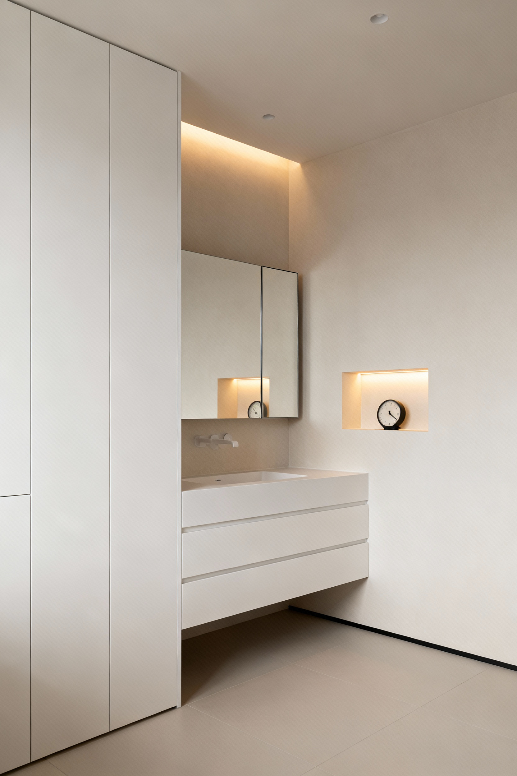 Modern bathroom with seamless white hidden storage cabinets, recessed mirrored medicine cabinet, and a vanity designed for hidden storage, creating a decluttered, minimalist look.