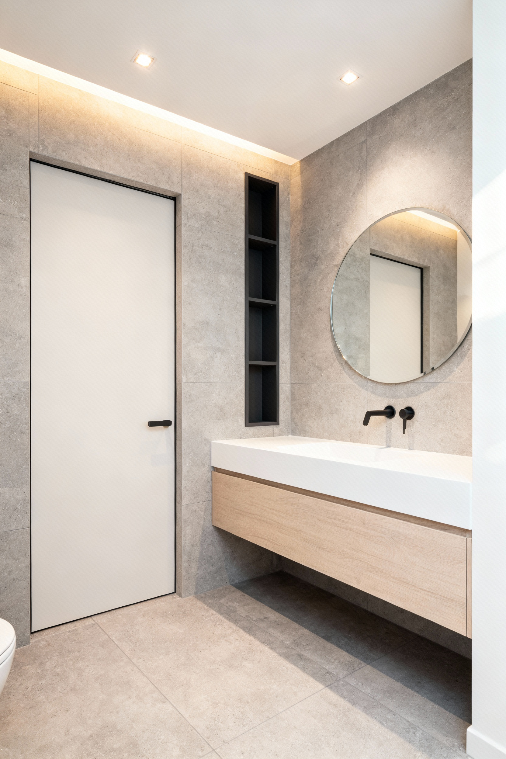 Small modern bathroom design showcasing a floating vanity and vertical storage unit made possible by the installation of a space-saving pocket door system.