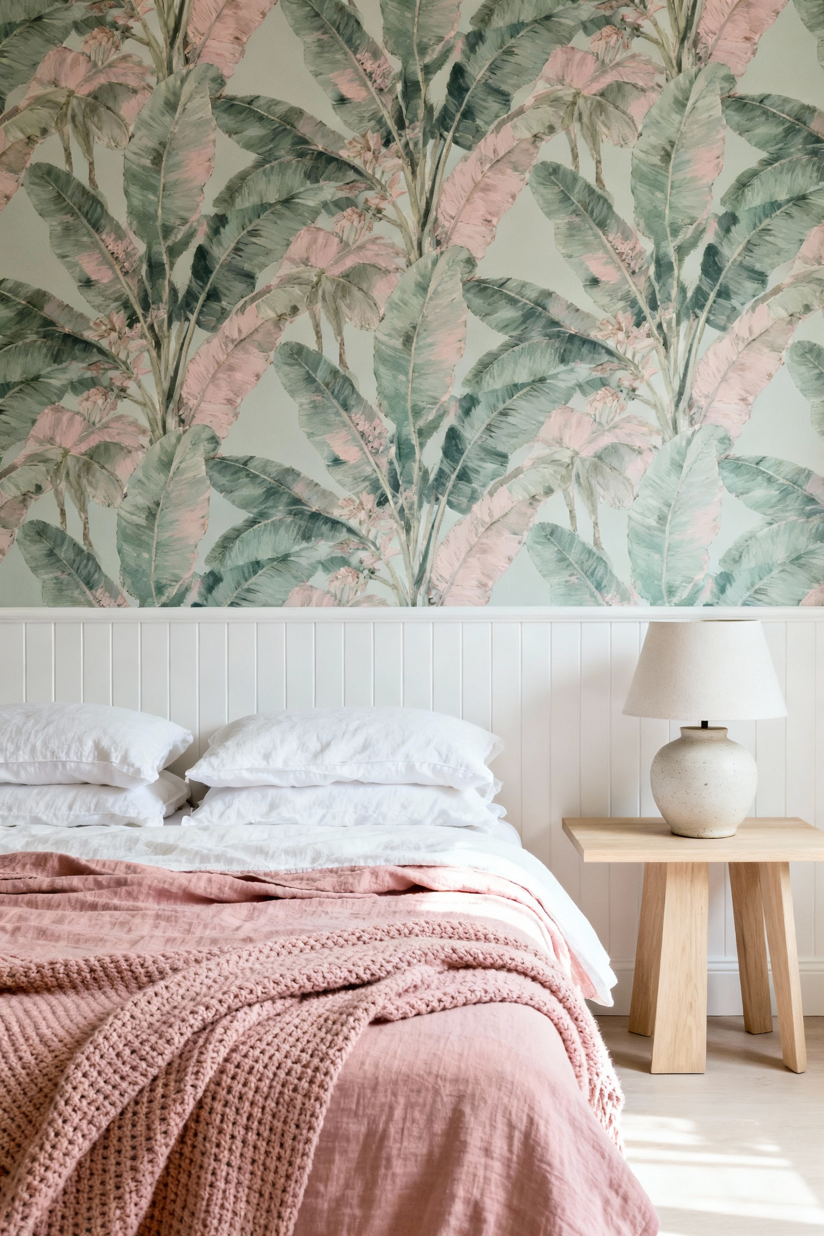 A vibrant girl's bedroom corner featuring a decorative feature wall defined by botanical removable wallpaper above a section of white beadboard wainscoting.