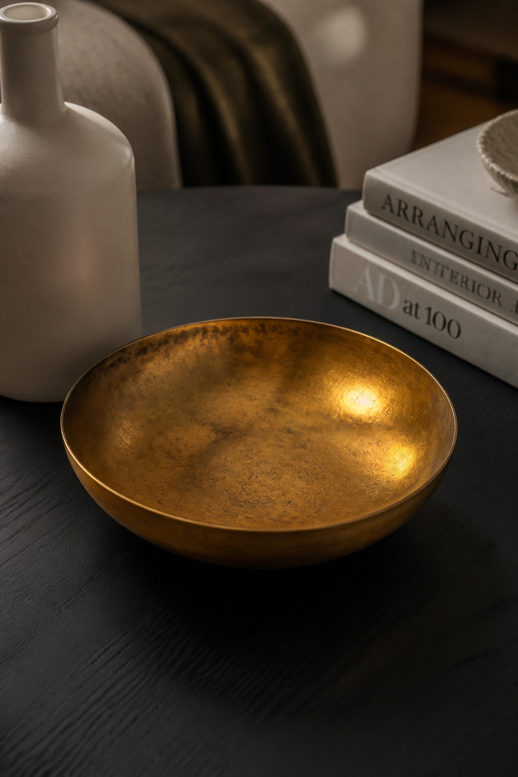 One warm brass bowl in an otherwise matte, natural arrangement creates a magnetic focal point — metallics catch light in a way that no other material can replicate.