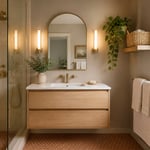 A complete small bathroom decor palette — warm paint, floating vanity, arched mirror, natural materials, and biophilic greenery — showing how each element reinforces the others to create a cohesive, calming space.