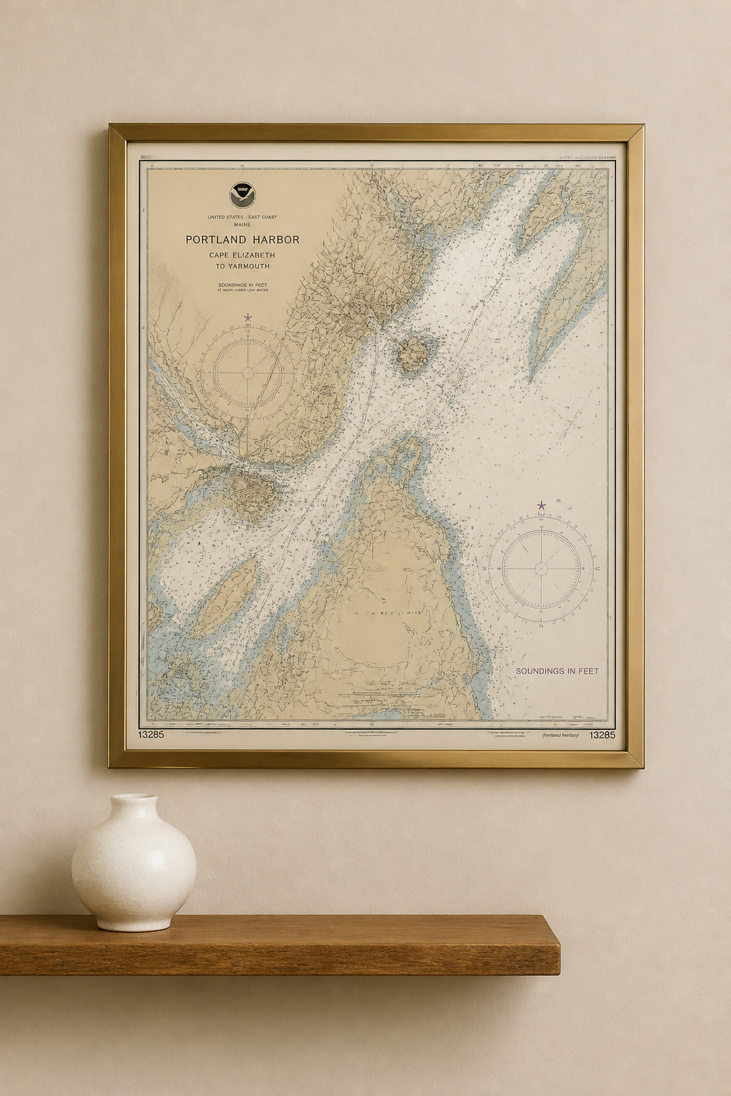 A vintage nautical chart in a brushed brass frame passes the gallery test that separates curated coastal art from themed decoration.