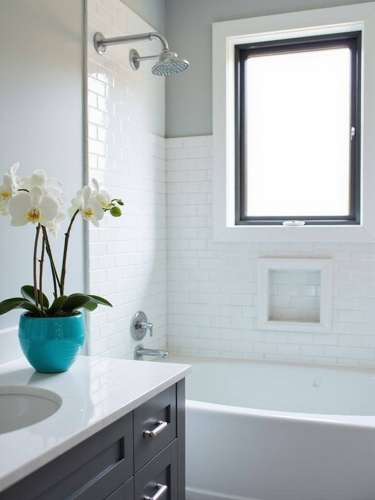 Modern bathroom with gray and white color scheme and a pop of turquoise from a vase of orchids.
