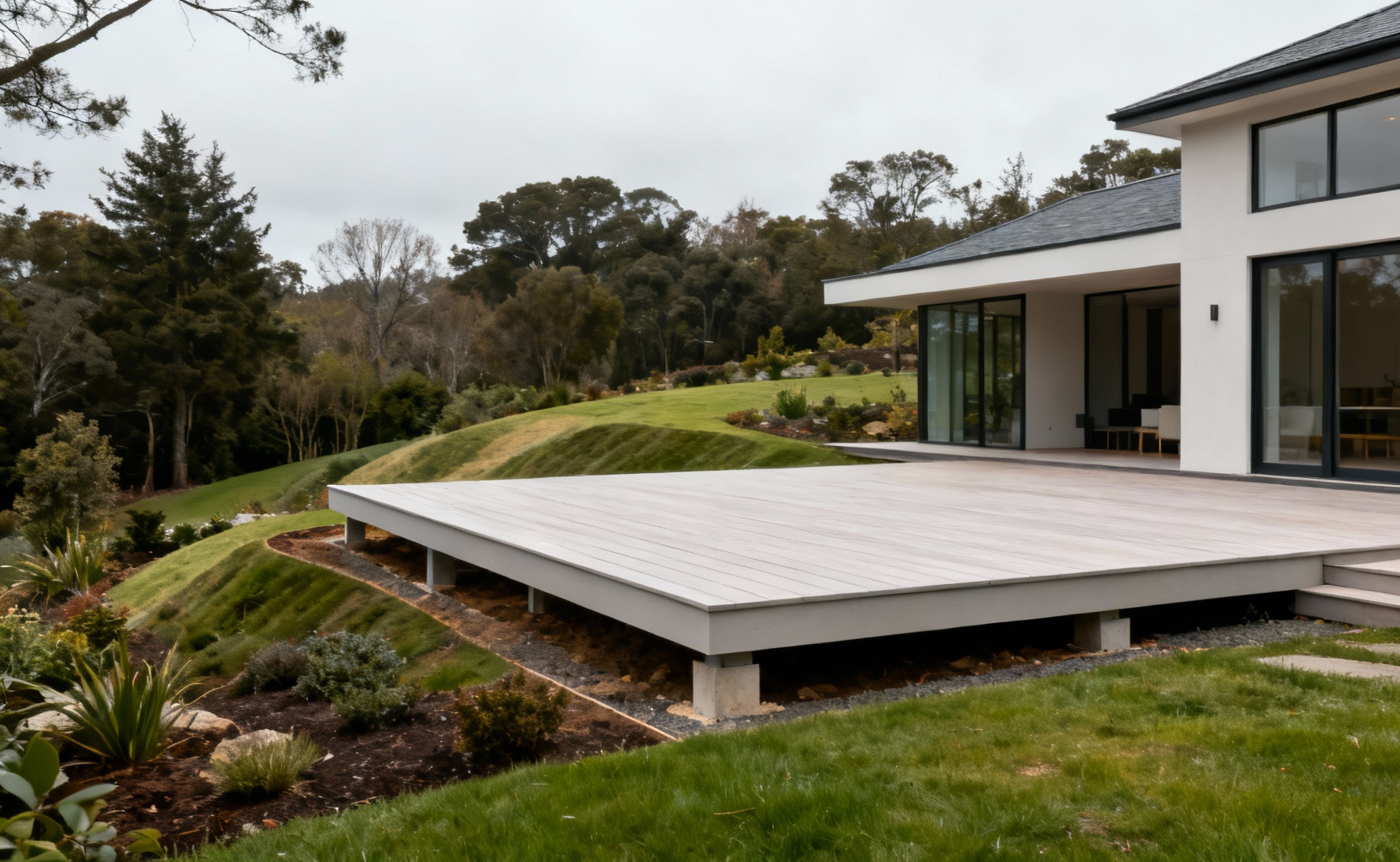 Modern home with a seamlessly integrated deck, demonstrating harmonious architectural flow within the landscape.