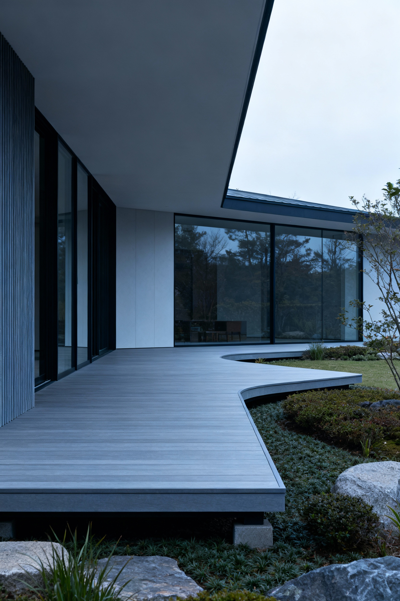 Modern home with a seamlessly integrated deck, demonstrating harmonious architectural flow within the landscape.