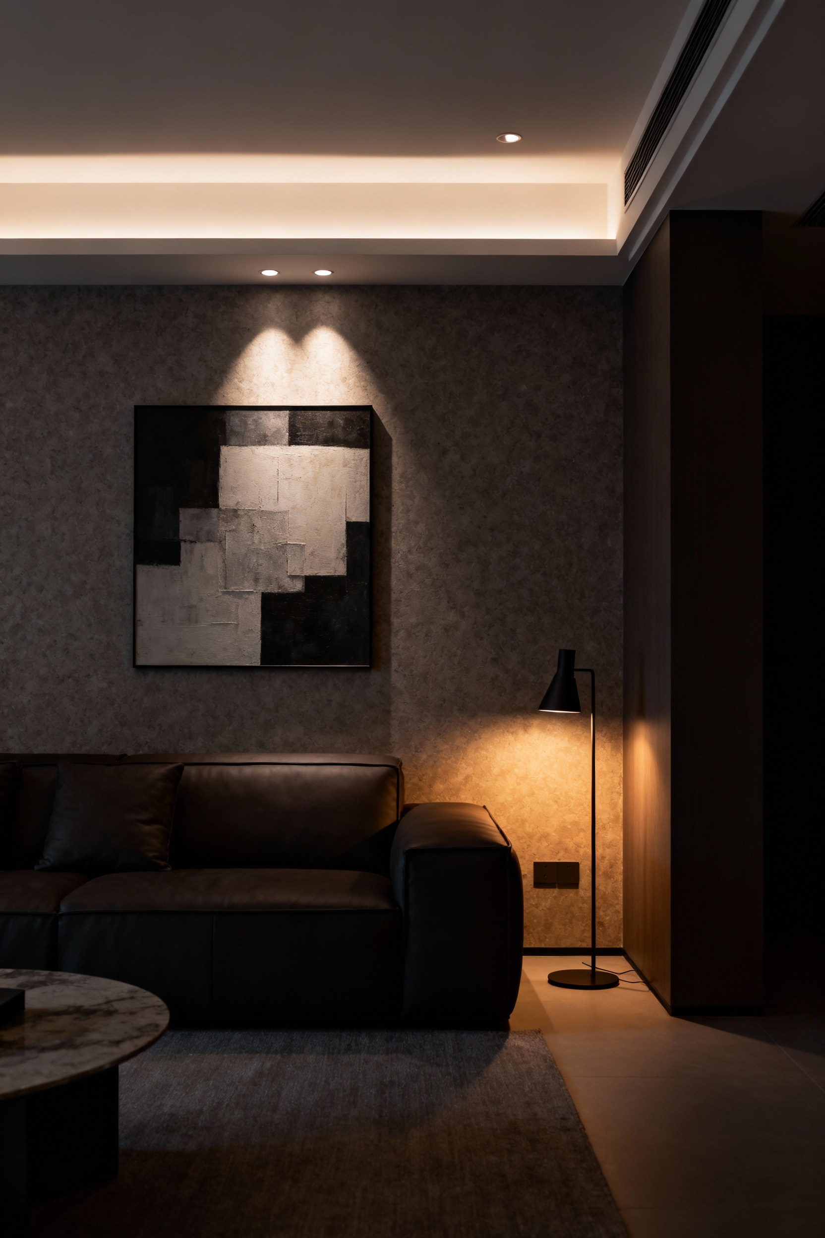 A modern living room showcasing the power of dimmable control systems, with various light sources like cove lighting, accent lights on art, and recessed downlights at different intensities creating a layered, atmospheric glow. Granular luminescence regulation in a sophisticated residential space.