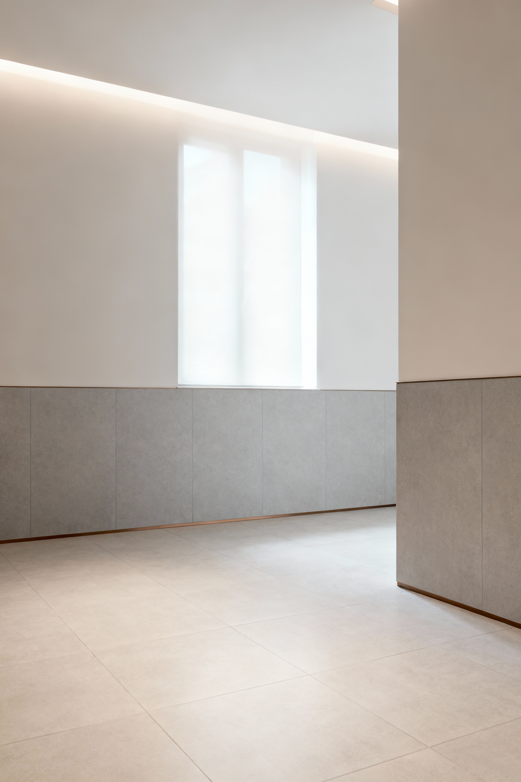 A modern bathroom featuring light-colored, matte porcelain tiles on floors and walls, illuminated by soft, diffused natural and artificial light to prevent glare and enhance visual clarity for universal design.