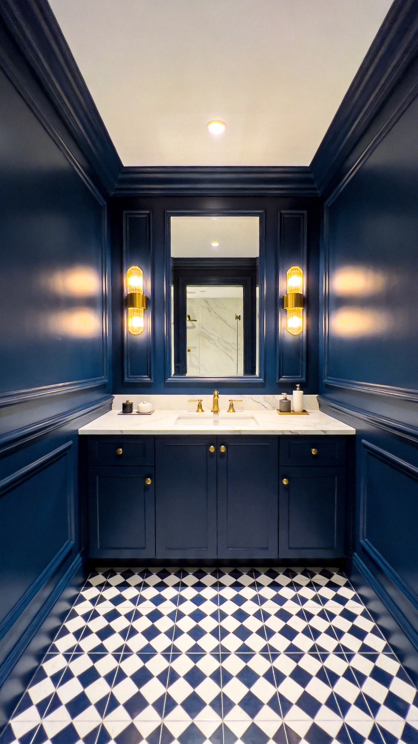 A small bathroom featuring symmetrical design and dark navy blue color drenching for a soothing atmosphere.
