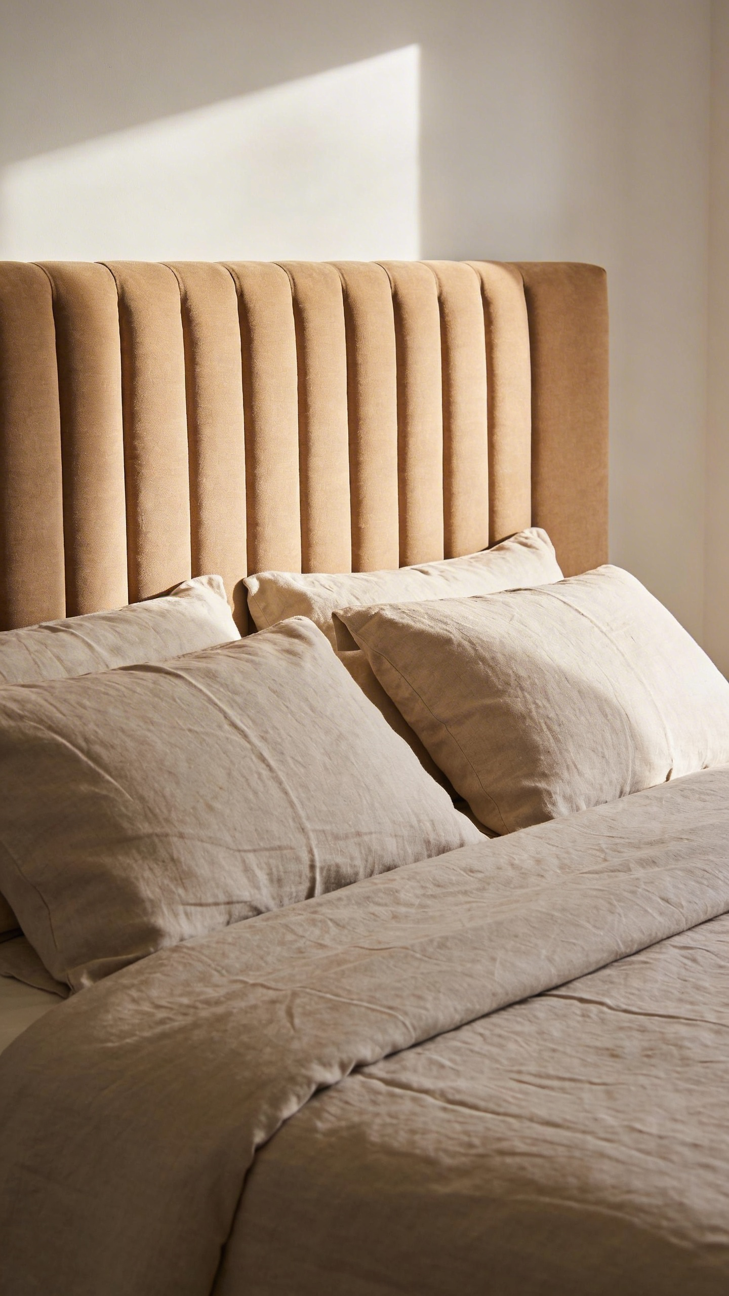 A well-proportioned upholstered headboard in linen or velvet anchors a bedroom visually — one of the most effective single-purchase cozy bedroom decor ideas for transforming a sleeping space.