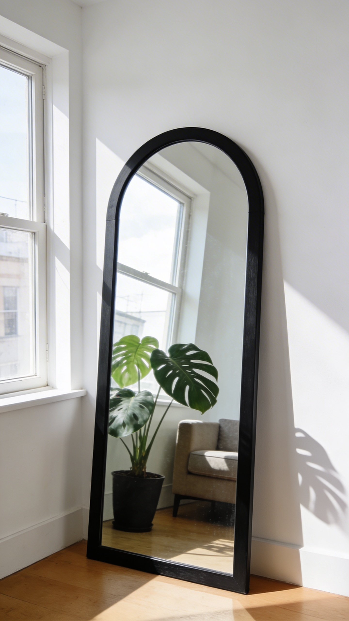 An oversized mirror placed opposite or adjacent to a window can double the apparent brightness of an apartment living room — one of the highest-impact, lowest-cost decoration moves available to renters.