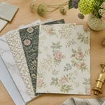A curated selection of kitchen wallpaper samples alongside natural materials and brass fittings — a visual starting point for finding the kitchen wallpaper inspiration that fits your space and style.