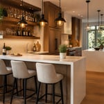 A warm, well-designed open-plan kitchen with a peninsula bar counter and upholstered stools captures every element of a functional entertaining space — from the quartz overhang to the curated glassware shelf above.