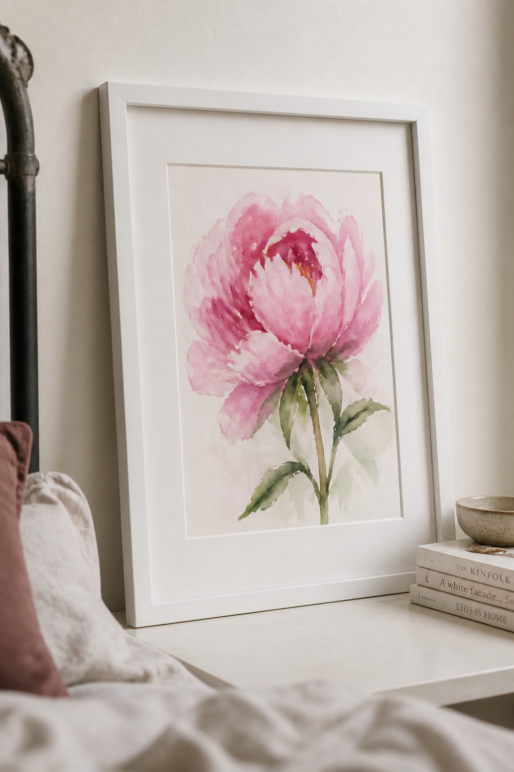 A loose, handmade watercolour of a peony brings irreplaceable personal warmth to a bedroom wall that no print can replicate.