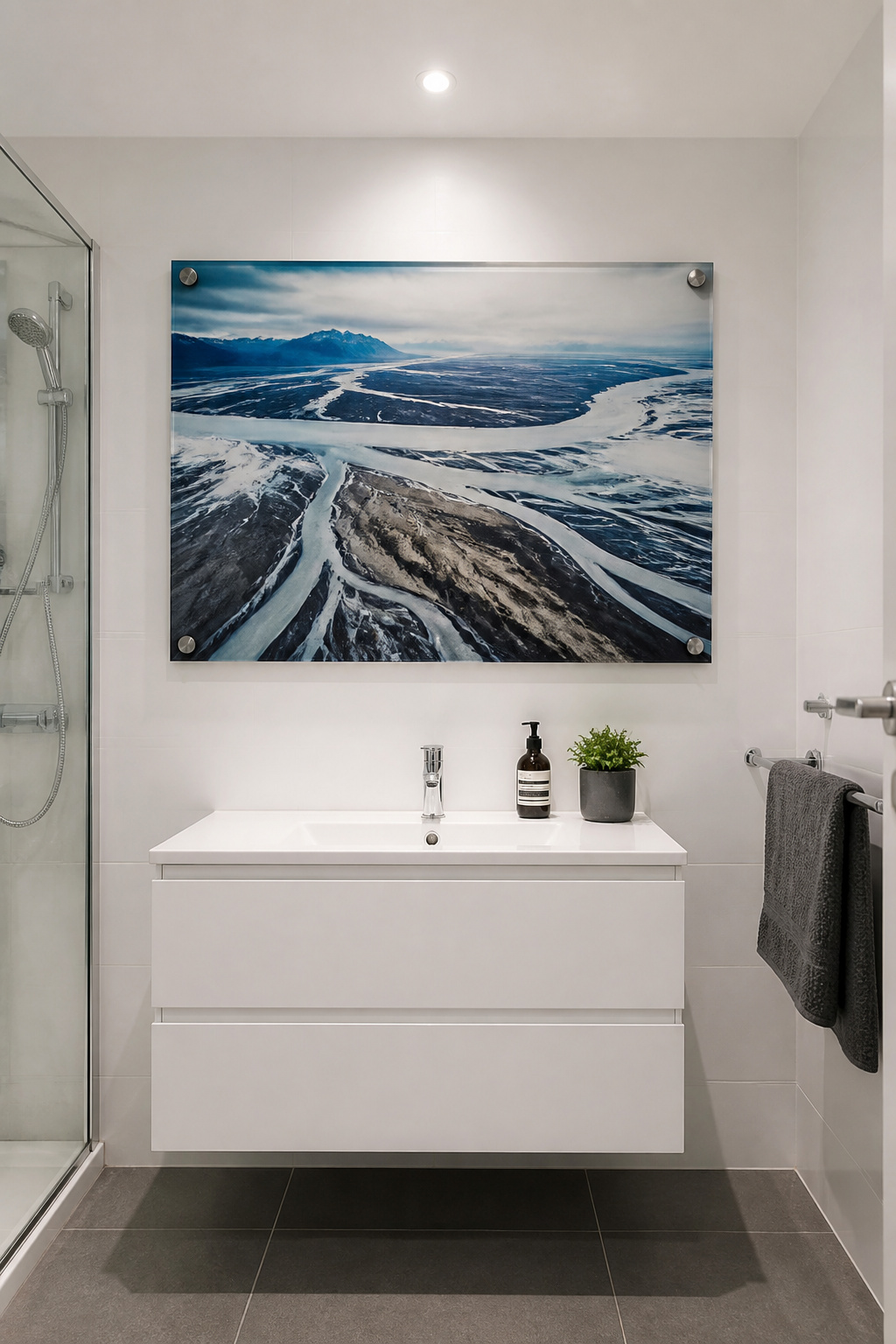 A single 24x36 acrylic-mounted landscape photograph occupying 70% of the wall width demonstrates how one oversized piece transforms a compact space.