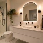 A thoughtfully designed apartment bathroom shows how floating fixtures, layered lighting, and a well-chosen mirror can make a small space feel genuinely considered.