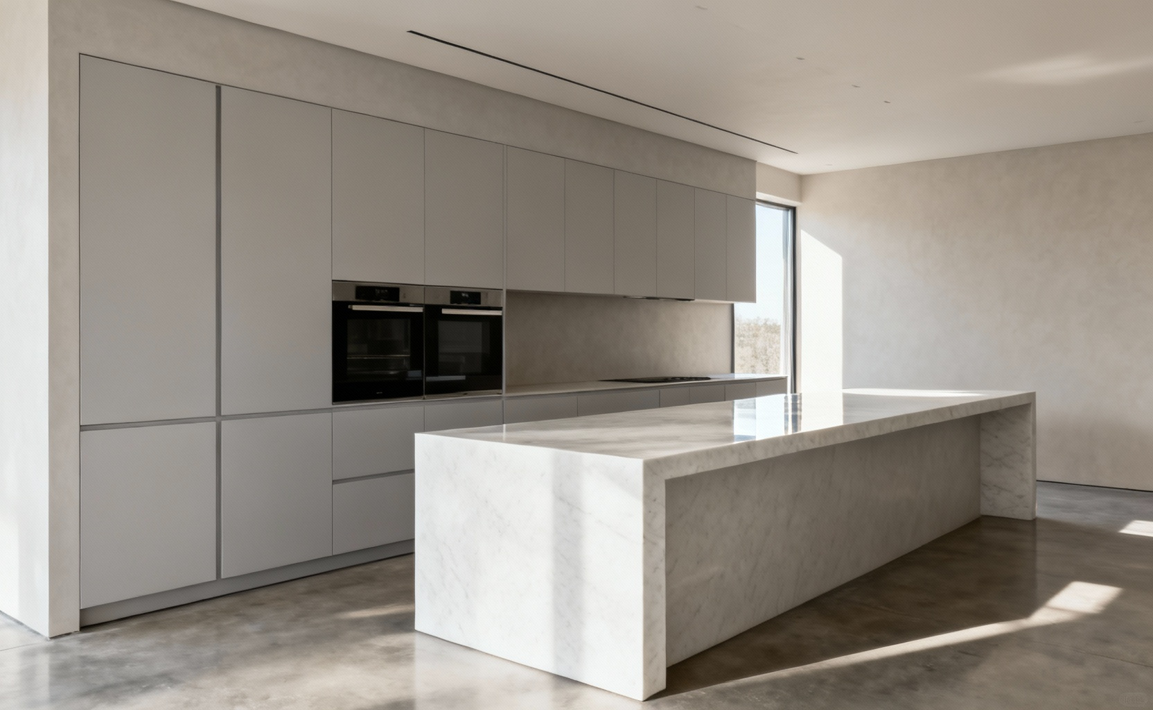 A professional photograph of a sleek, minimalist contemporary kitchen. The scene showcases integrated, handle-less appliances seamlessly concealed behind flush light grey cabinetry, with a pristine honed white marble countertop. The overall impression is one of profound clarity, sophisticated efficiency, and functional elements acting as organic ornamentation, devoid of clutter.