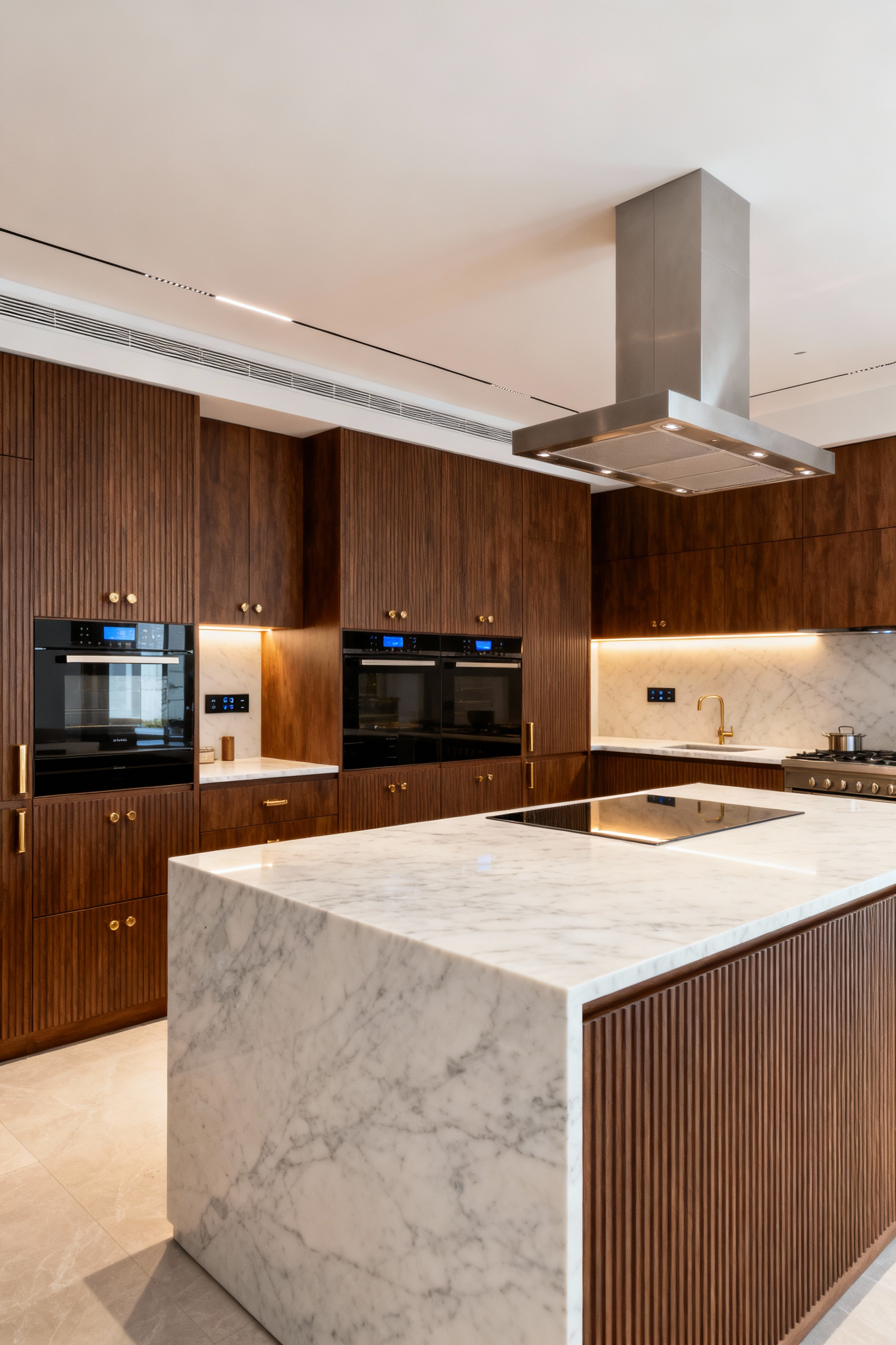 Modern luxury kitchen with ergonomic design, featuring a honed Calacatta marble island, fluted walnut cabinetry, integrated appliances, and brushed brass accents for seamless culinary flow.