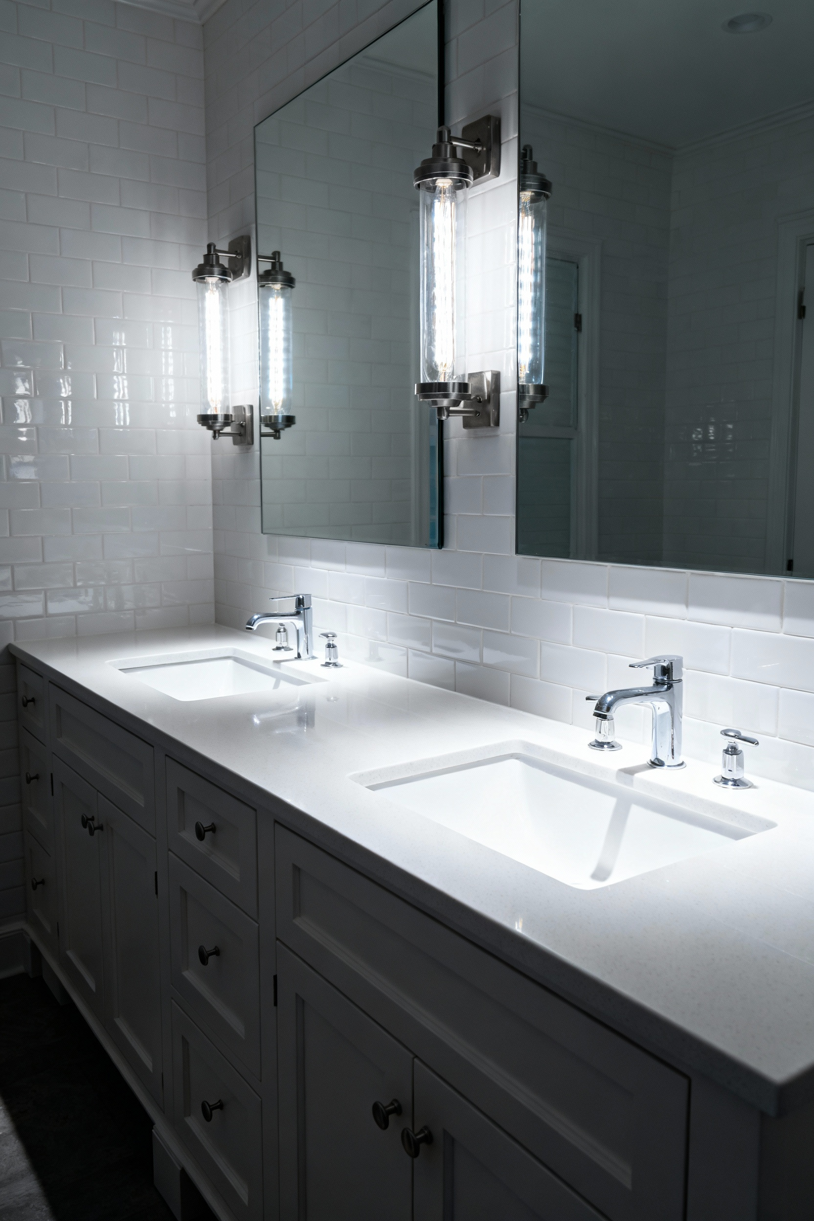 A photograph demonstrating the effect of harsh overhead lighting on a white bathroom vanity and quartz countertop, showing stark shadows under the counter lip and aggressive glare across the reflective white surfaces.