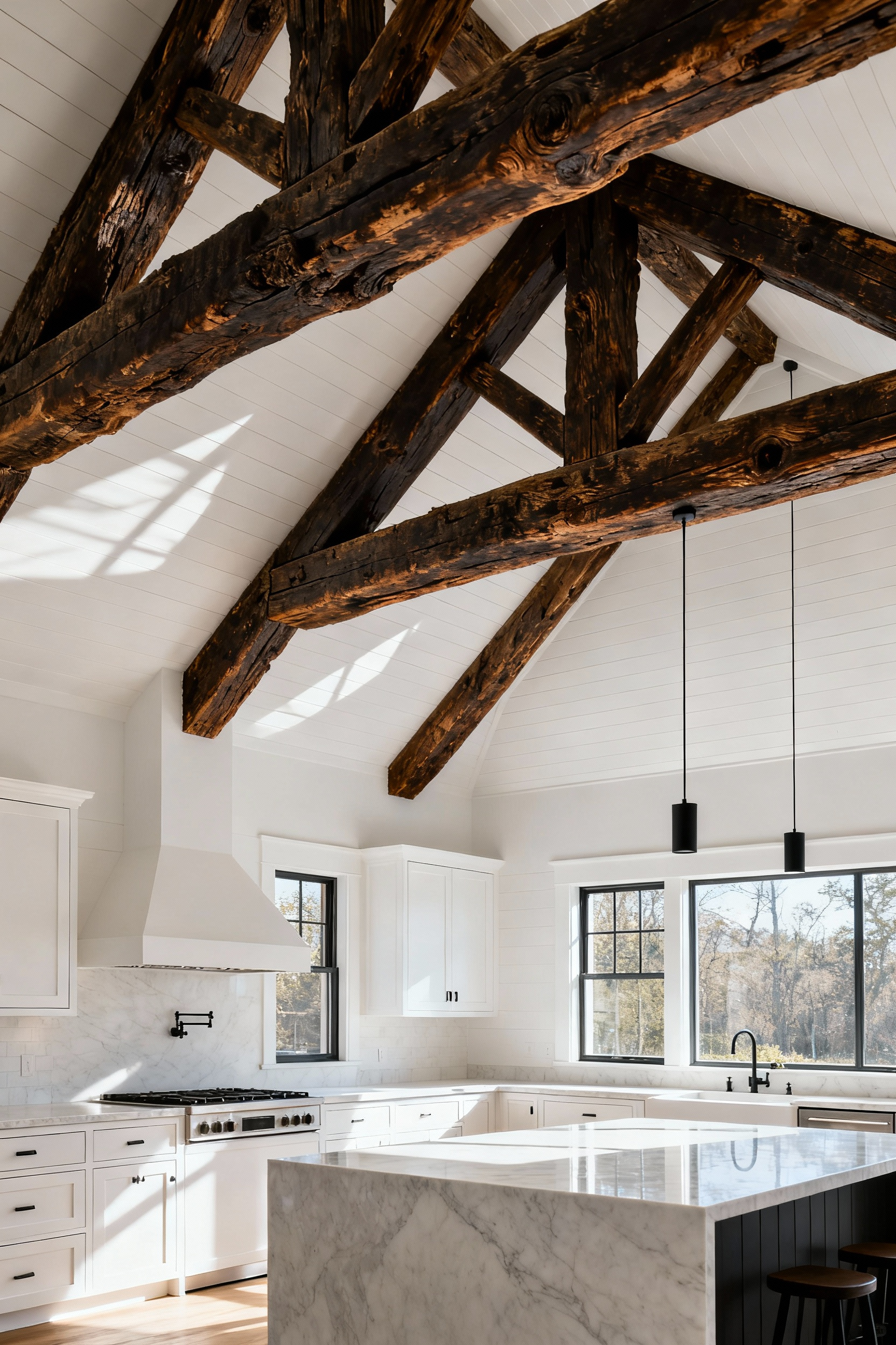 A bright modern farmhouse kitchen ceiling showcasing large, exposed, dark antique timber beams contrasting against white shiplap, emphasizing historical restoration.
