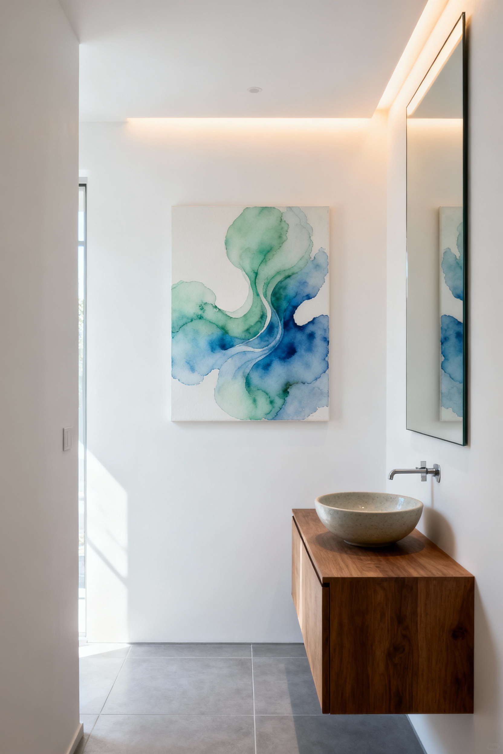 Elegant small bathroom interior featuring a large abstract watercolor painting in blues and greens above a floating vanity, serving as a tranquil focal point, illuminated by a subtle accent light, enhancing visual serenity.