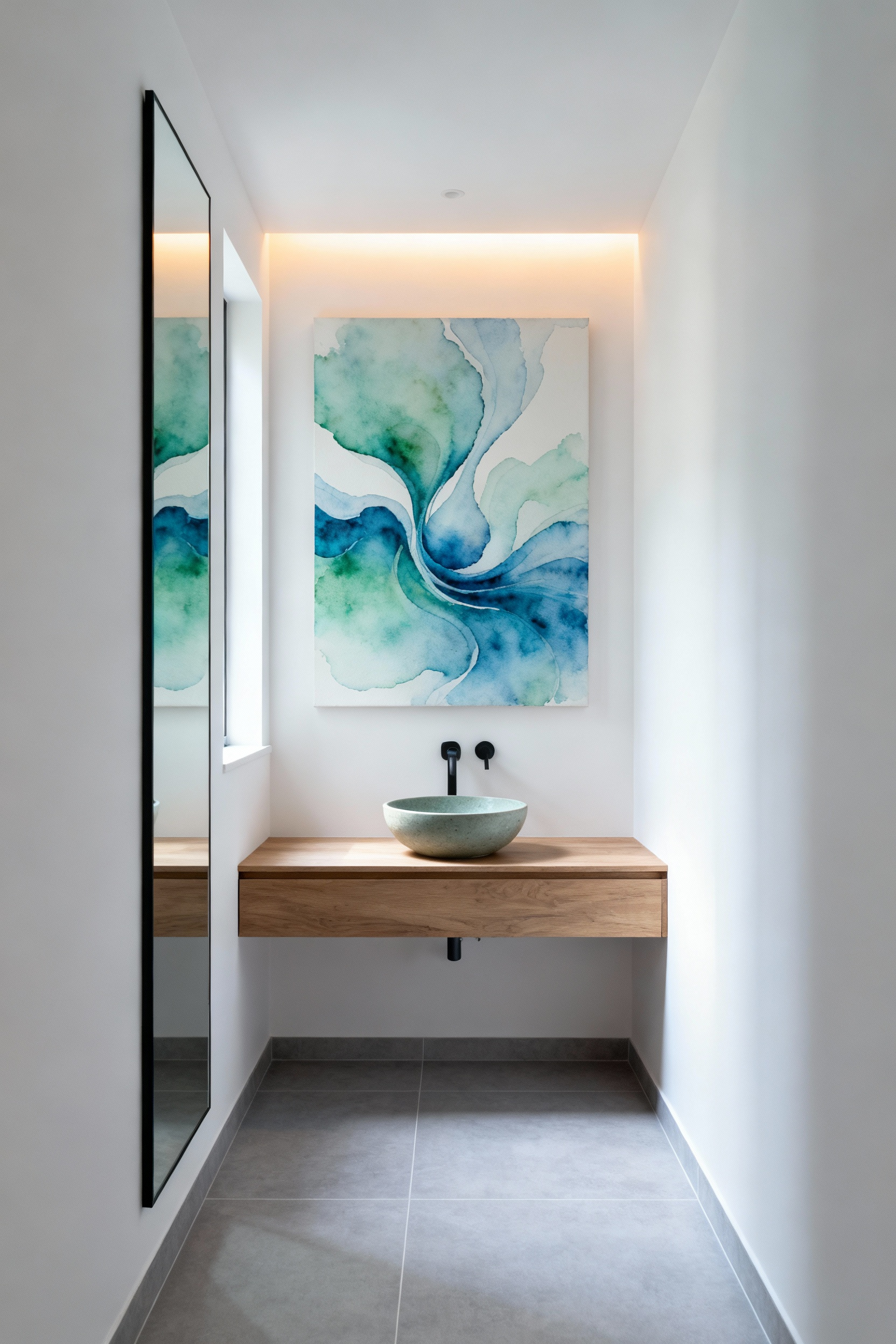 Elegant small bathroom interior featuring a large abstract watercolor painting in blues and greens above a floating vanity, serving as a tranquil focal point, illuminated by a subtle accent light, enhancing visual serenity.