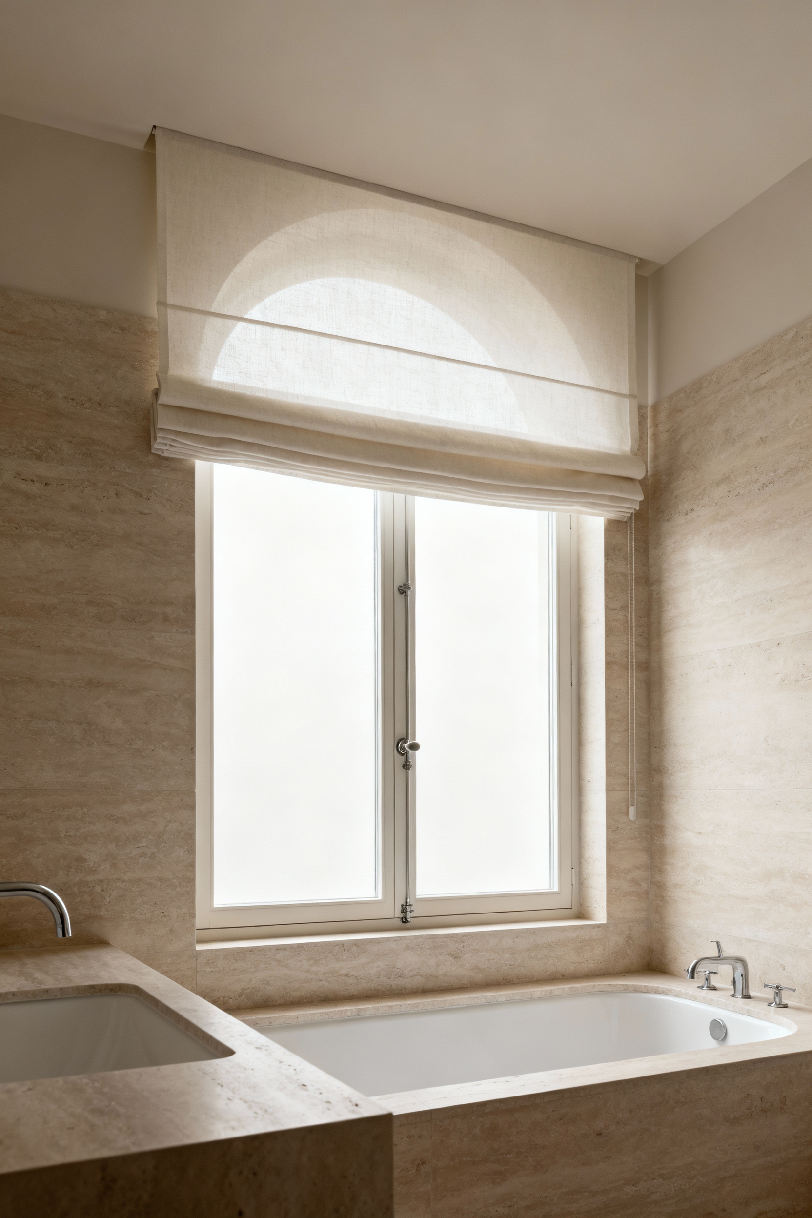 A modern bathroom window featuring a light-colored valance positioned strategically to soften architectural lines and provide discretion, illuminated by natural light.