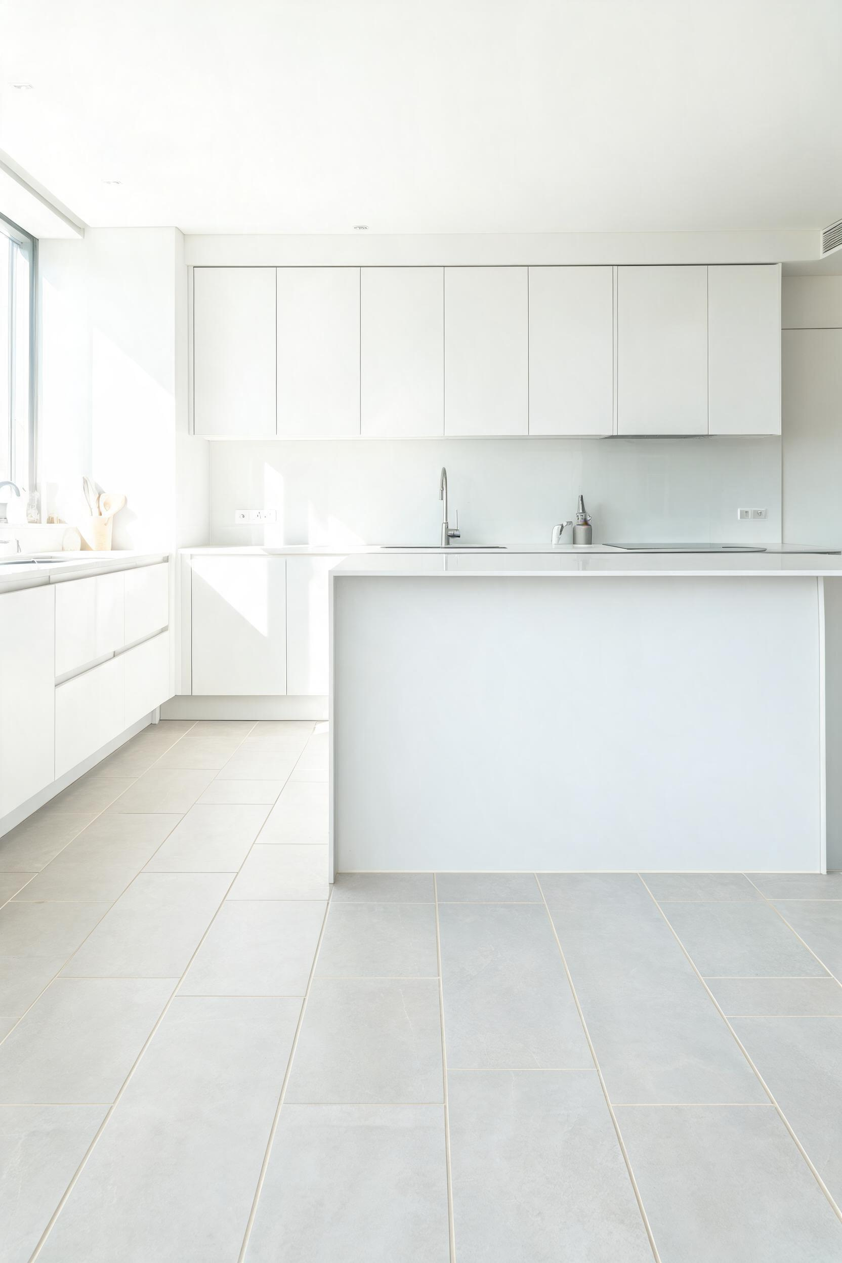 Large-format floor tiles reduce grout lines and create a sense of continuous surface that makes any kitchen feel larger and more intentional — a defining detail in a modern kitchen makeover.