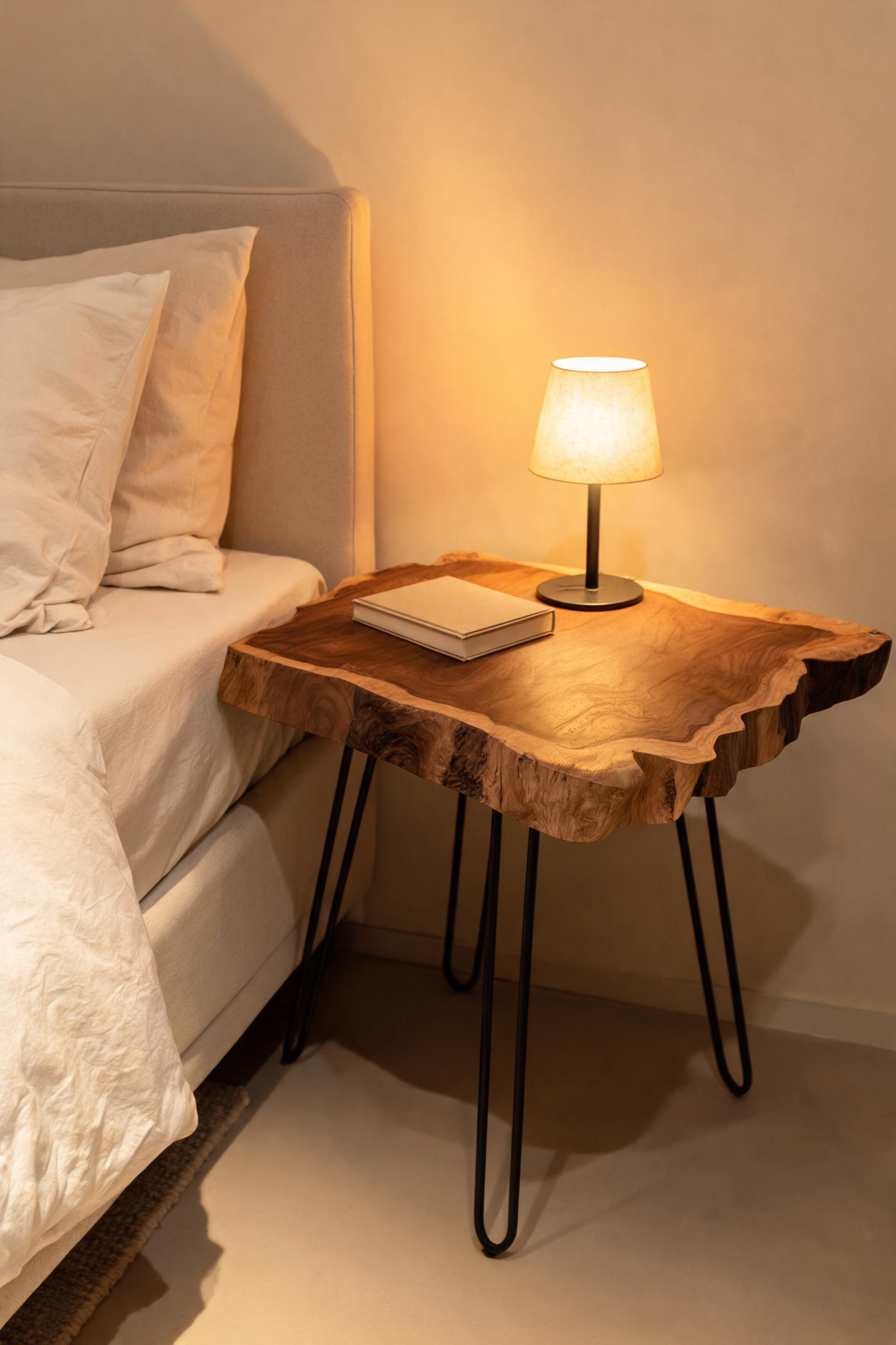 A live-edge walnut slab on hairpin legs brings tree-scale drama to a bedside table at a price point that surprises most people.