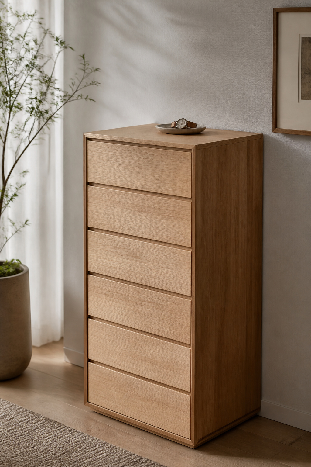 A tall, narrow dresser with handleless push-to-open drawers takes half the wall space of a conventional wide unit while holding equivalent storage.