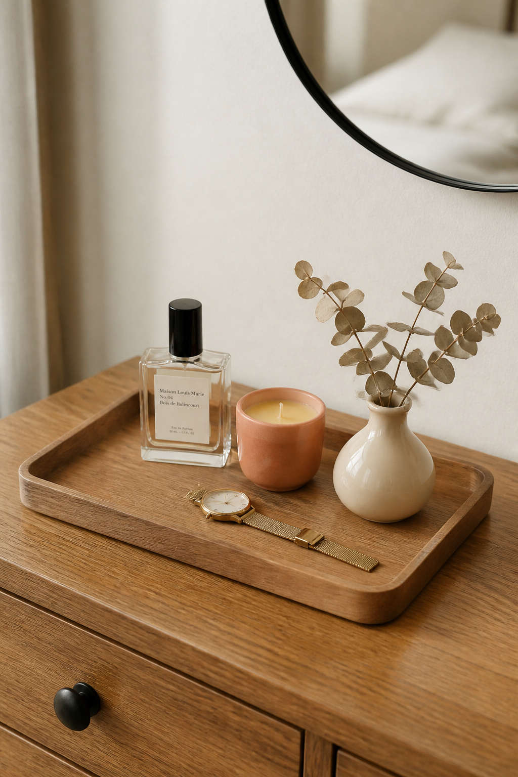 A natural acacia wood tray on the dresser turns everyday objects into a composed moment without requiring a single deliberate design decision.
