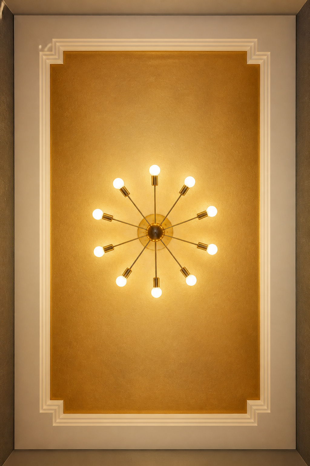 A tray ceiling with the recessed panel painted in matte gold — completable in a weekend — is the most impactful Art Deco ceiling treatment available without structural work.