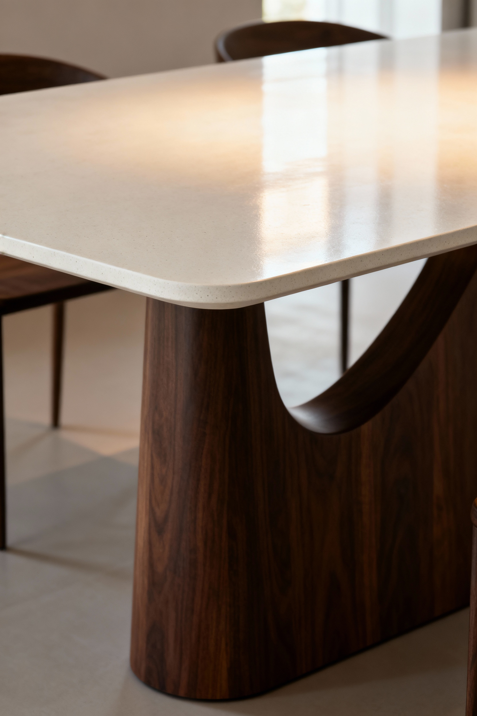 Modern dining table with a walnut base and UHPC top, showcasing ergonomic design and sophisticated material juxtaposition in a minimalist setting. Focus on experiential design.