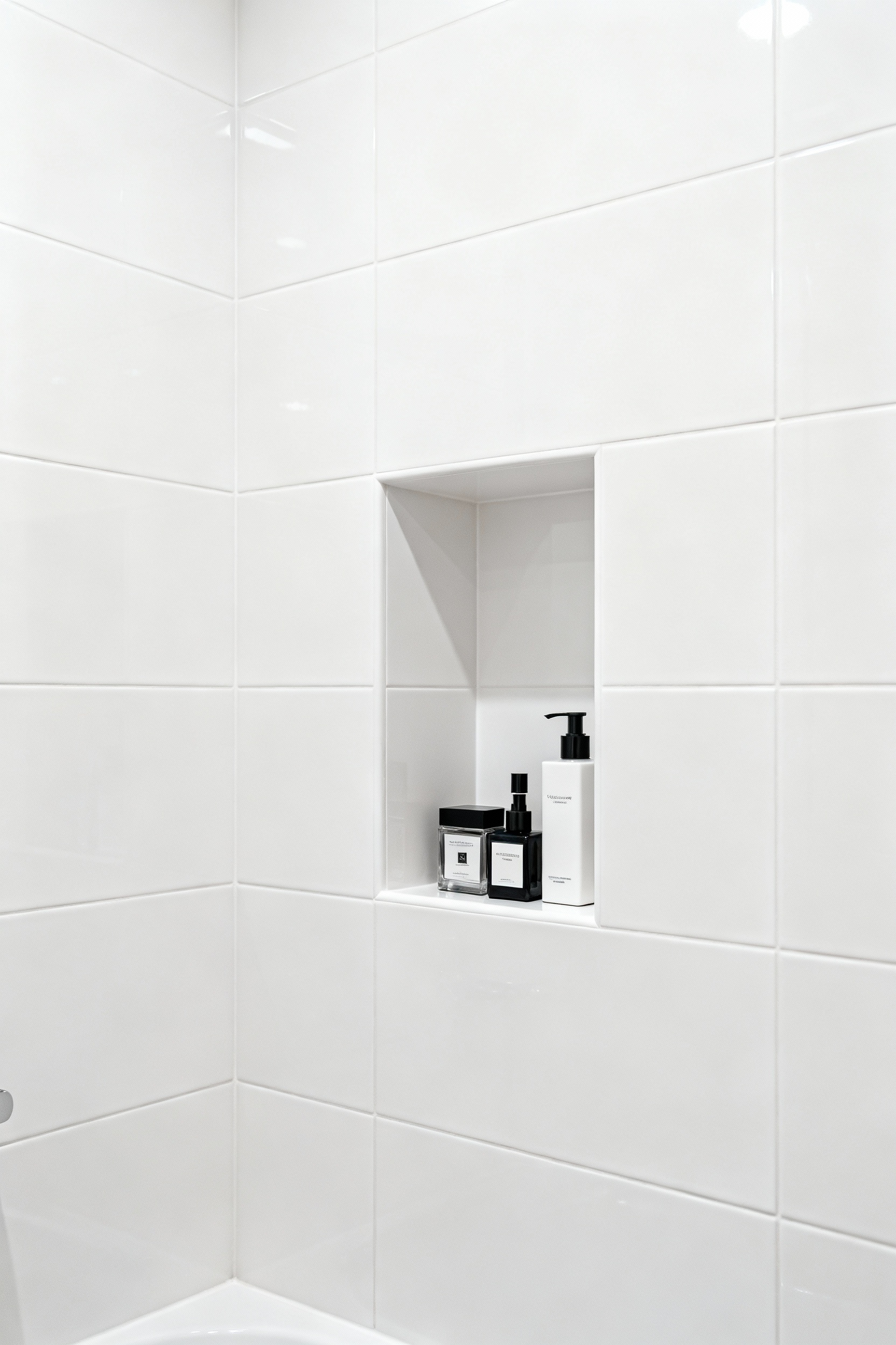 Small modern bathroom with a built-in recessed shower niche showcasing minimalist, integrated storage for a clean and uncluttered look.