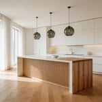 A curated modern kitchen showcasing the defining material choices of contemporary island design — waterfall quartz, mixed materials, and considered lighting — all working in cohesion.