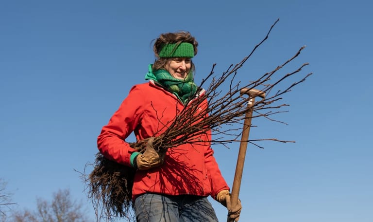 Dame met een bos takken onder haar arm