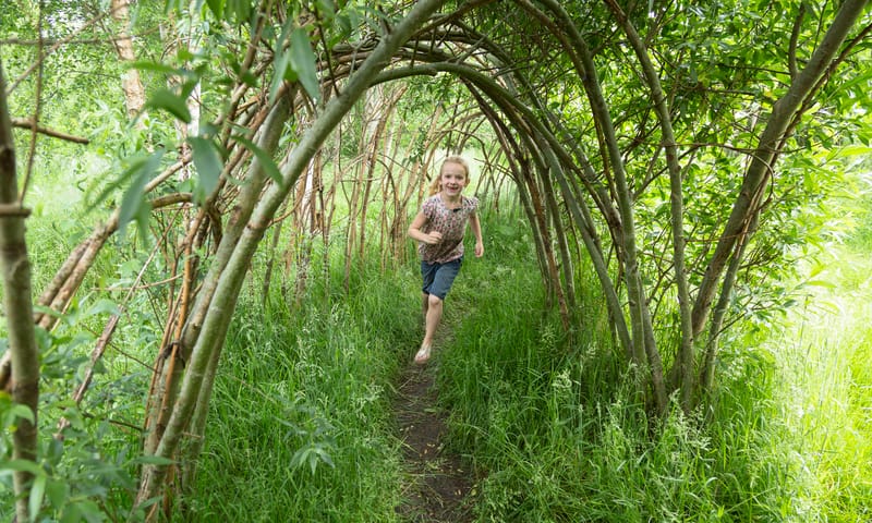 Meisje rent door wilgenhuttendorp