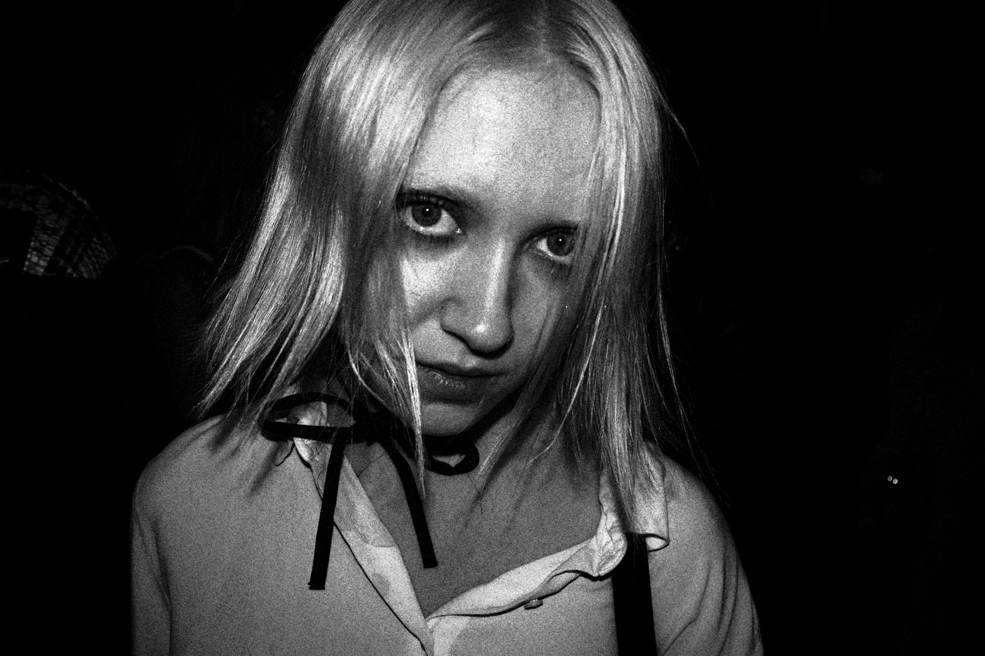 a woman looking at the camera with blond hair