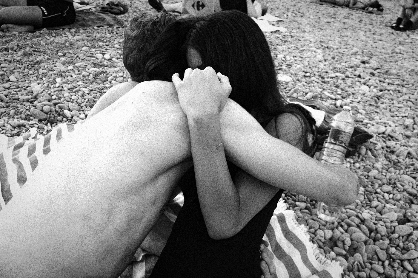 man and woman hugging on beach
