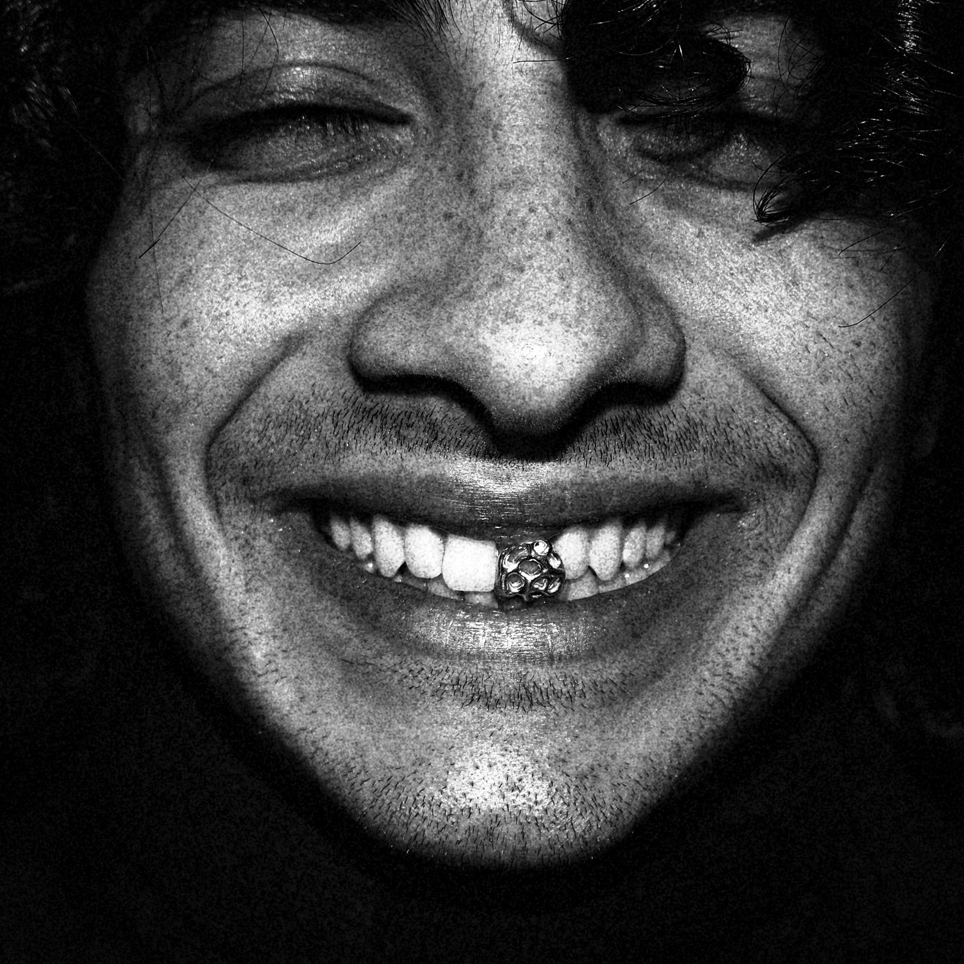 a man with a gem on his front tooth