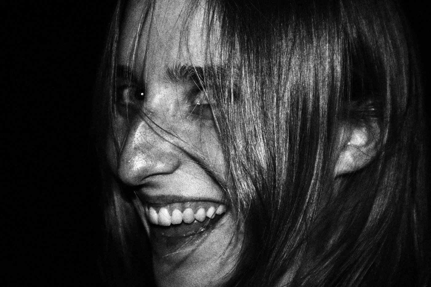 girl smilling with hair covering her face