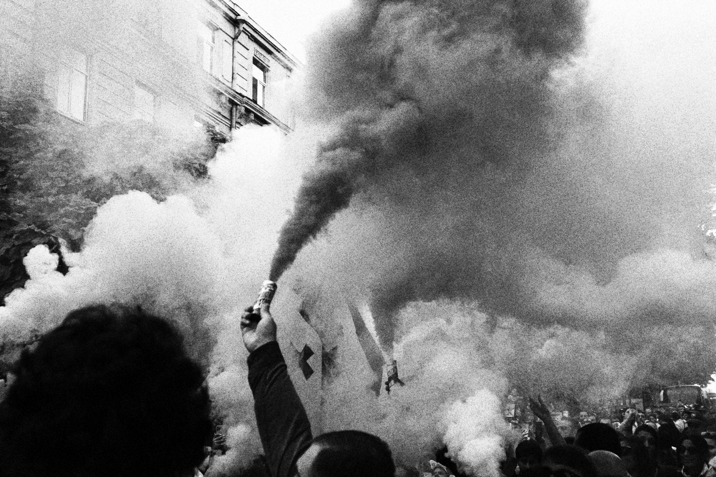 large protest in Tbilisi with lots of smoke 