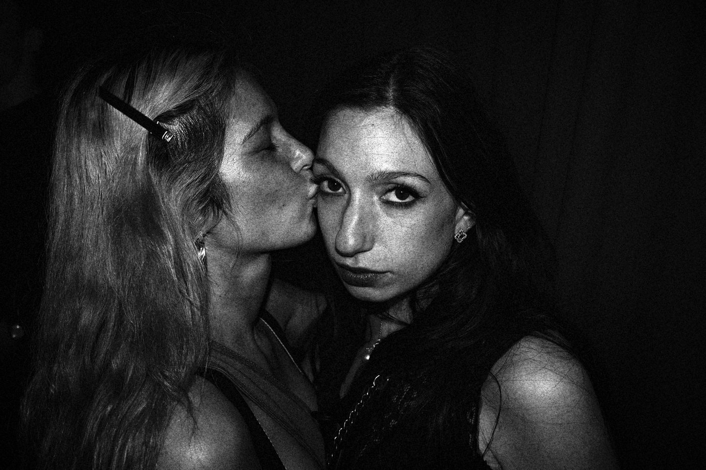 one girl kissing a girl on the forehead