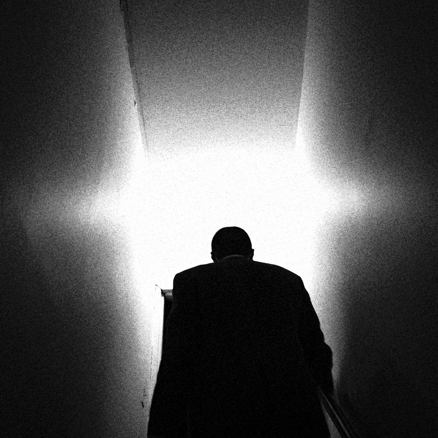 a man climbing a stairwell to light