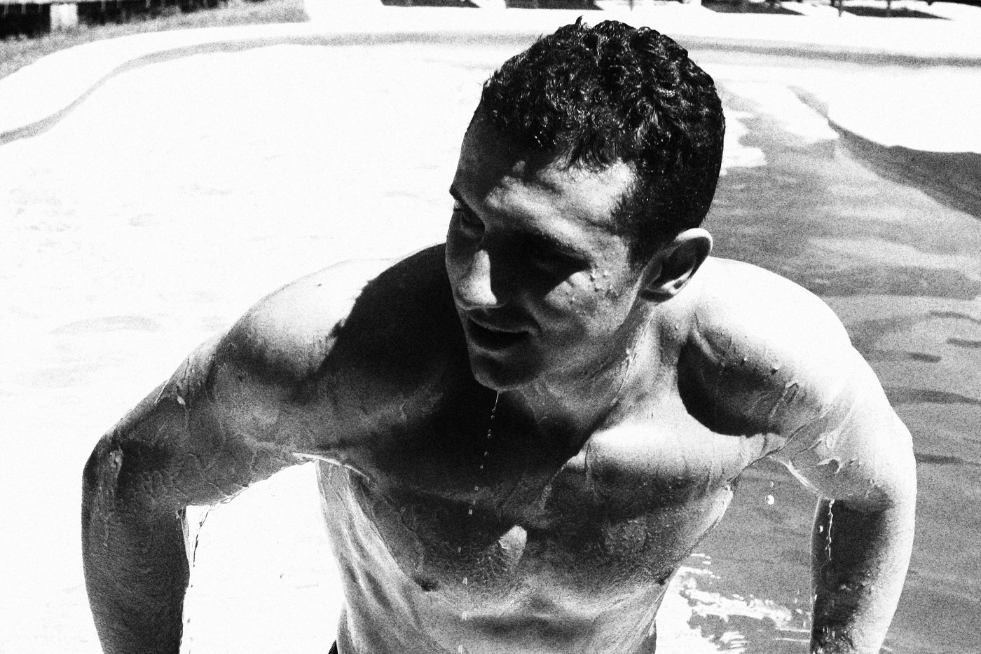 a man emerging from the a pool