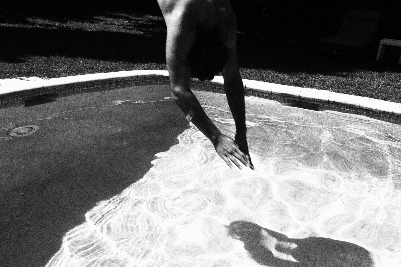 a man diving into a pool